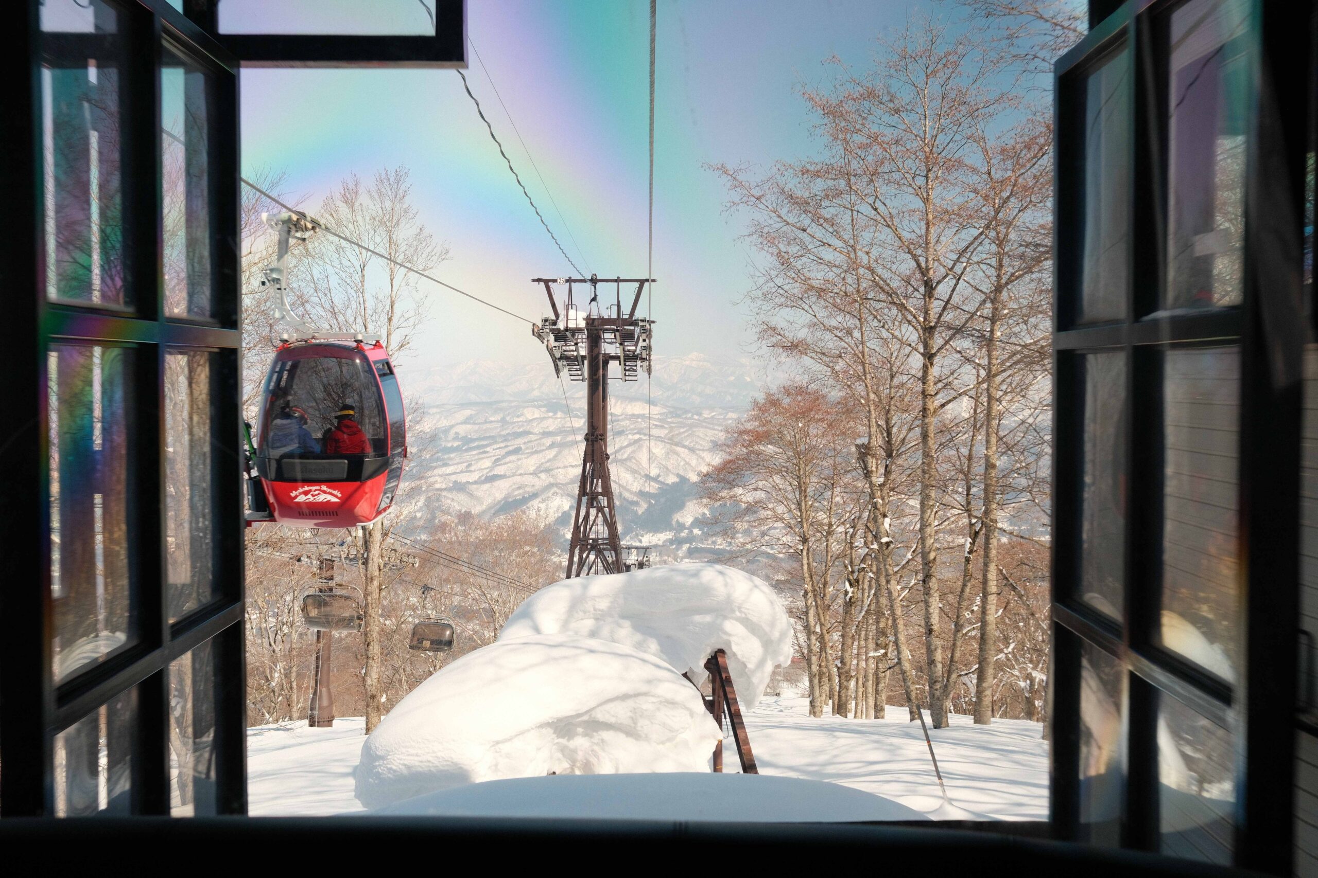 Gondola ascending through snowy mountains