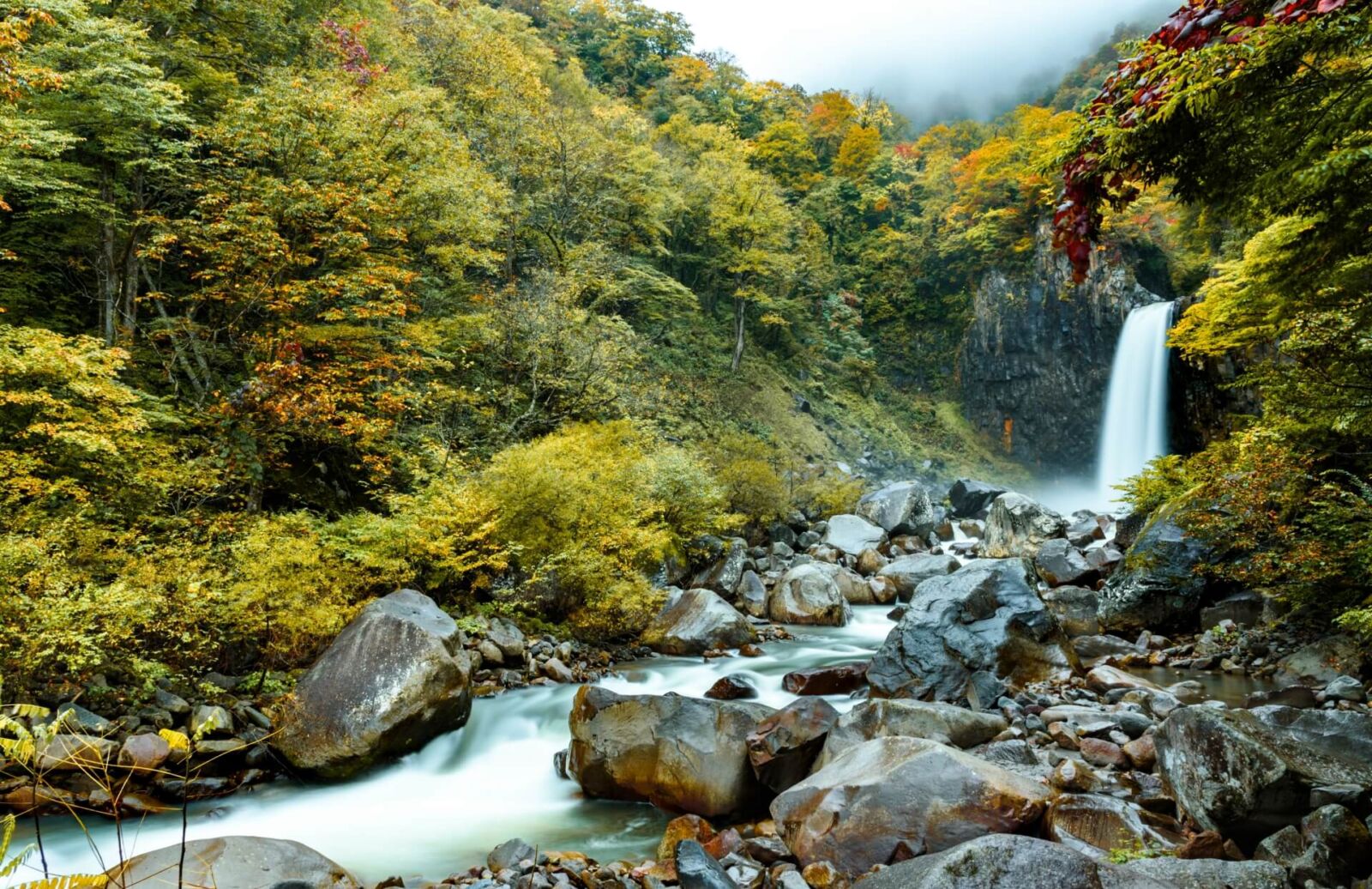 Waterfall cascading through forest near Myoko Kogen