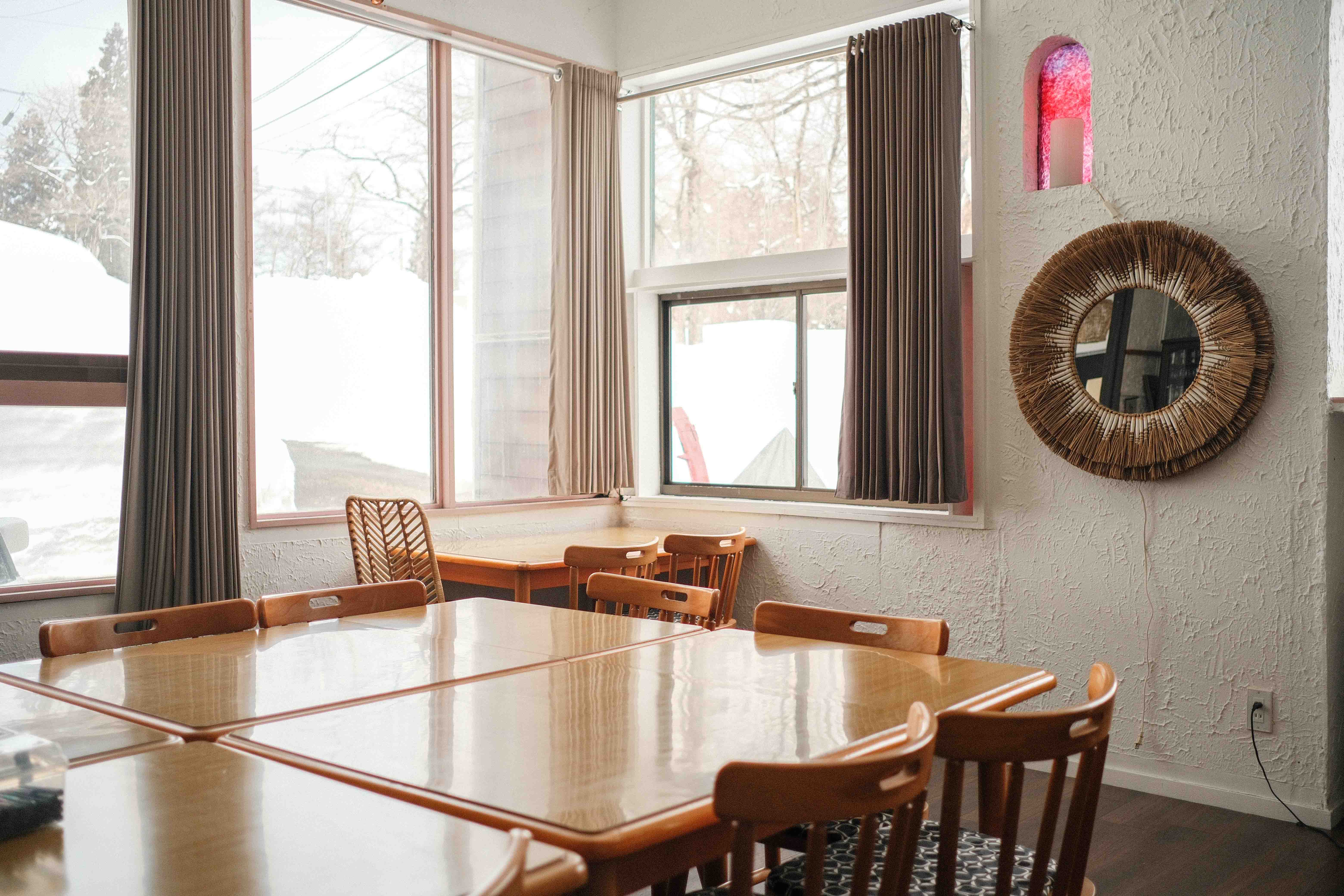 Dining area with sunburst mirror and natural light