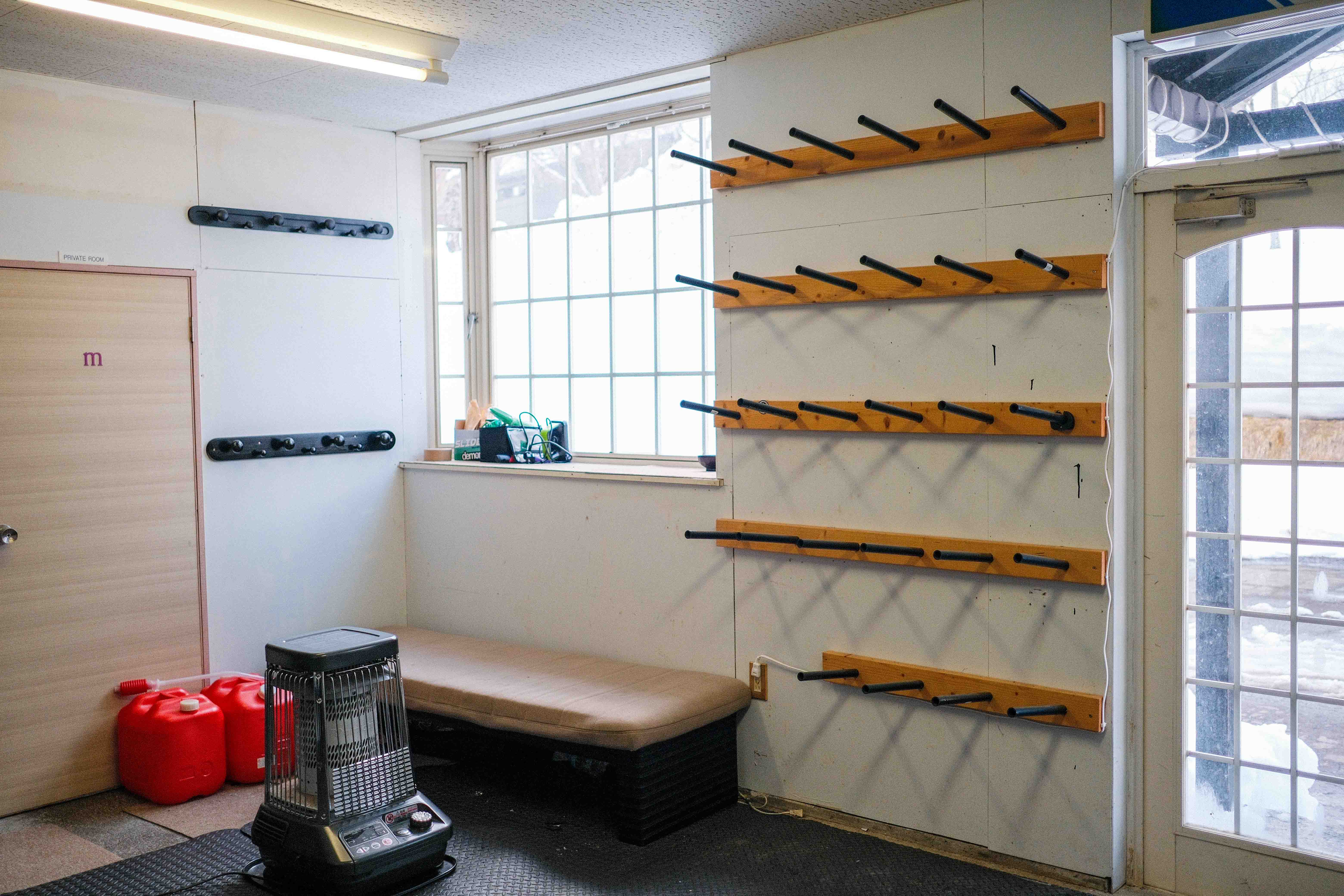 Ski room with board racks and boot dryers