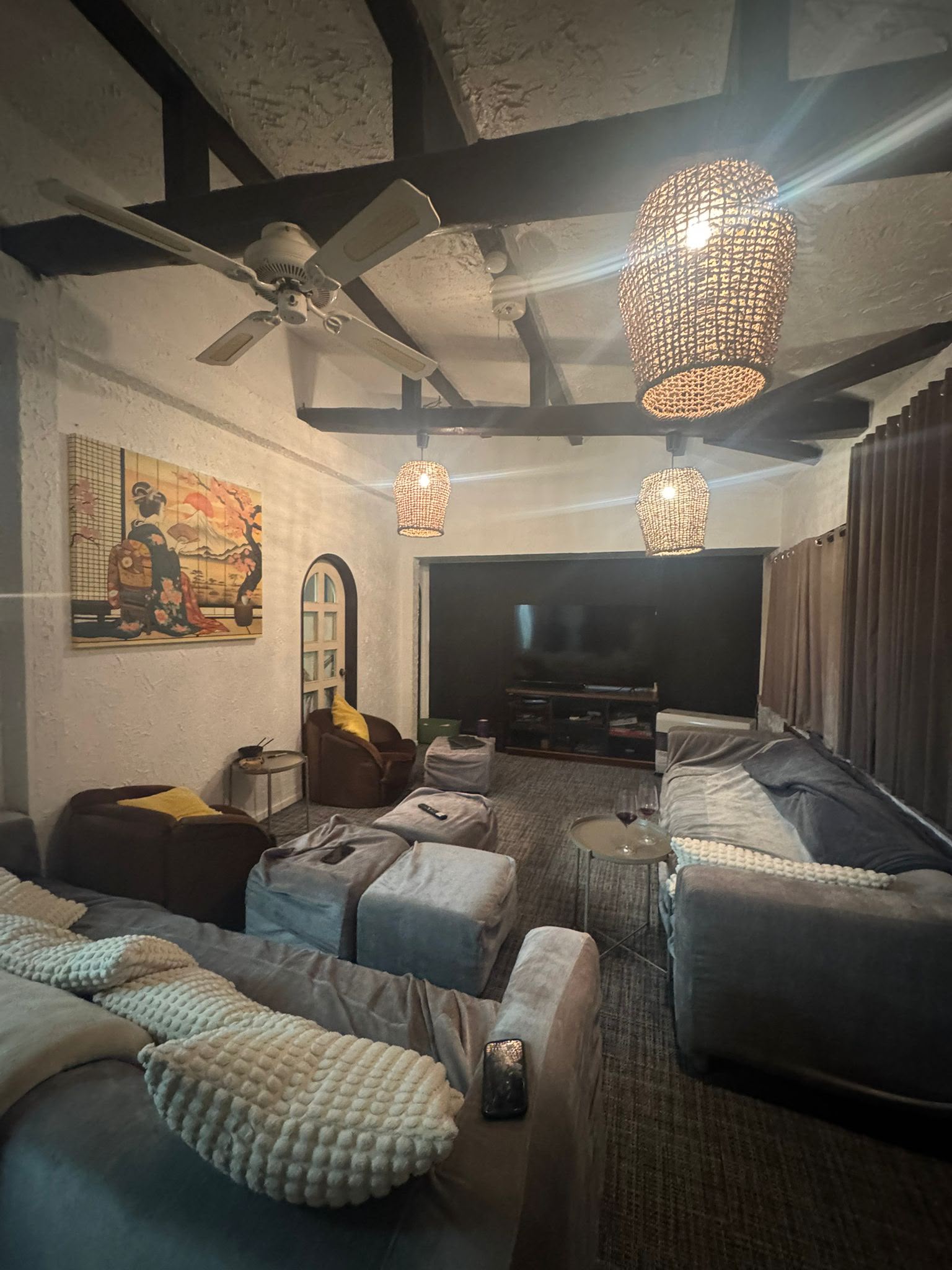 Living room with woven pendant lights and sectional seating